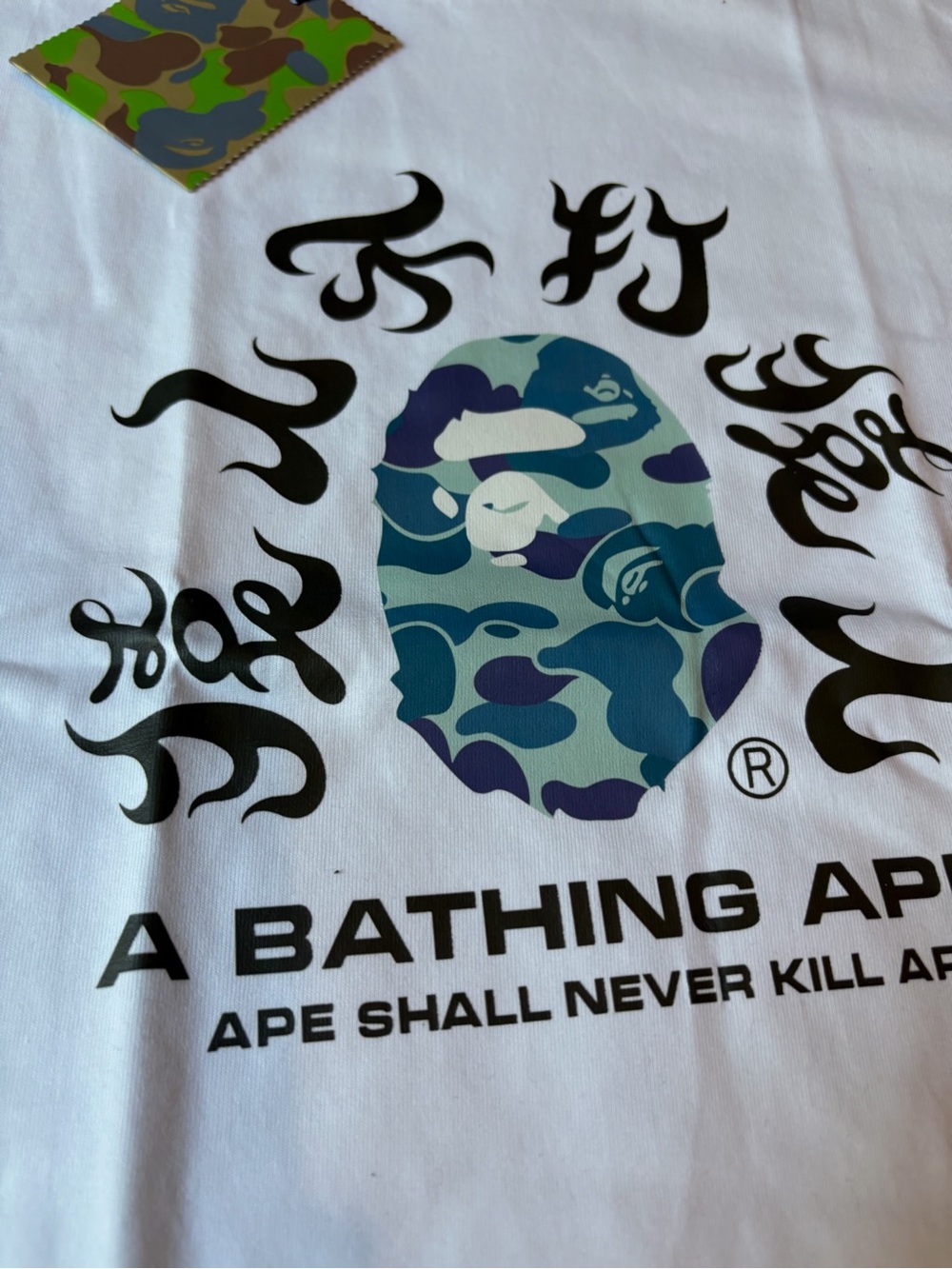 A Bathing Ape White Short Sleeve Tee with Blue/Green Camo Ape Head - Picture 2 of 9